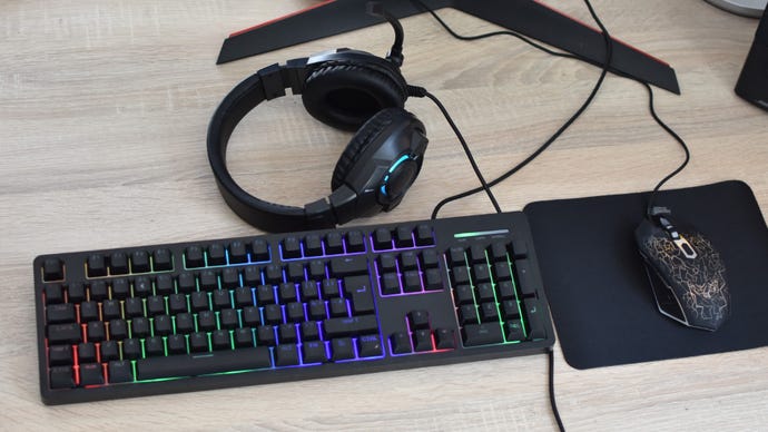 The Asda Tech 4-in-1 Gaming Kit's mouse, mousemat, keyboard and headset on a desk.