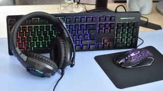 The contents of the Asda Tech 4-in-1 Gaming Kit - a mouse, keyboard, headset and mousemat - arranged on a desk.